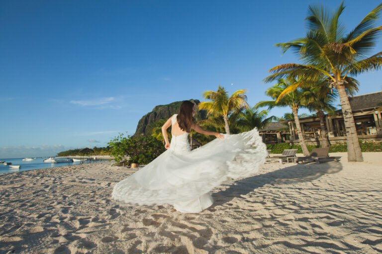 Beautiful bride in white dress on the beach